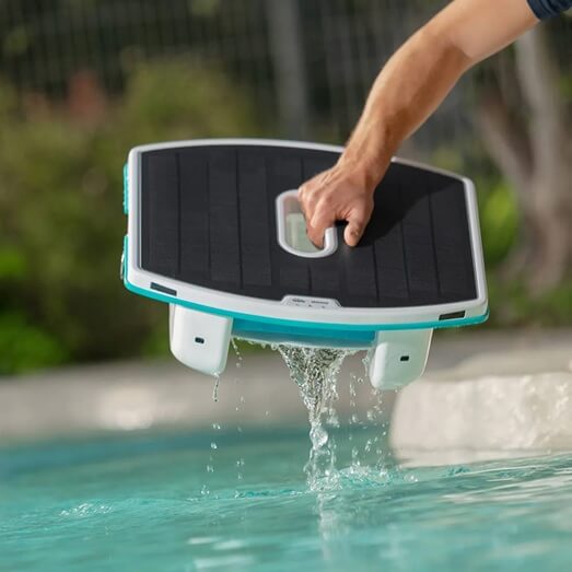 maytronics dolphin skimmi solar powered pool surface skimmer lifting out of pool close-up worldofpools